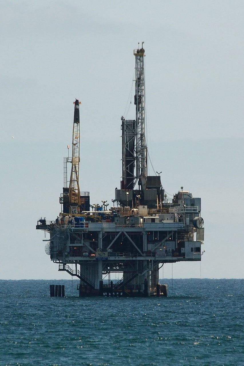 Offshore oil rig against gray sky.